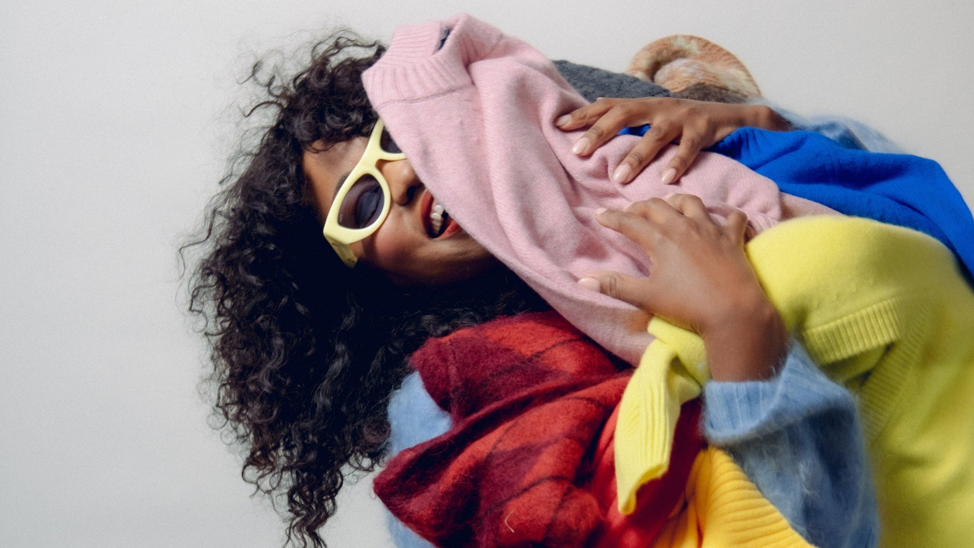 Person wearing colorful clothing with a neutral background